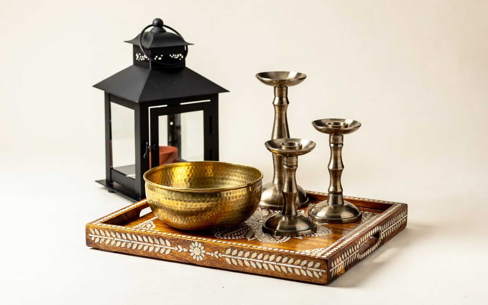 A booth-ready set of hammered brass and black iron décor, rendered